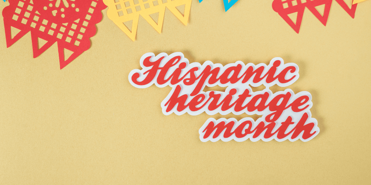 Colorful papel picado decorations with the text Hispanic heritage month on a yellow background