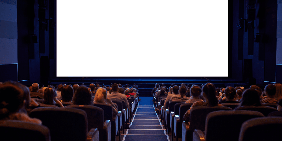 Empty cinema with an audience facing a large blank screen