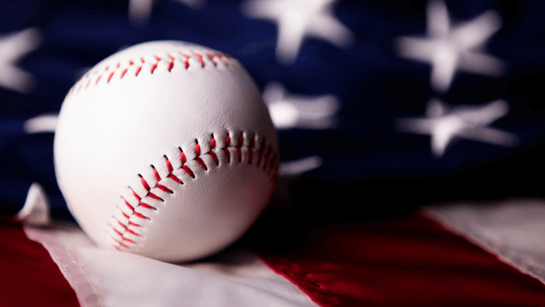 Baseball resting on an American flag representing MLB All-Star Week and America's pastime
