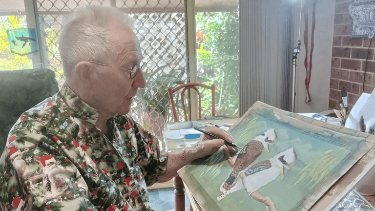 Les Peterkin OAM painting a kookaburra, part of his "Laughing Kookaburras" exhibition preparation.