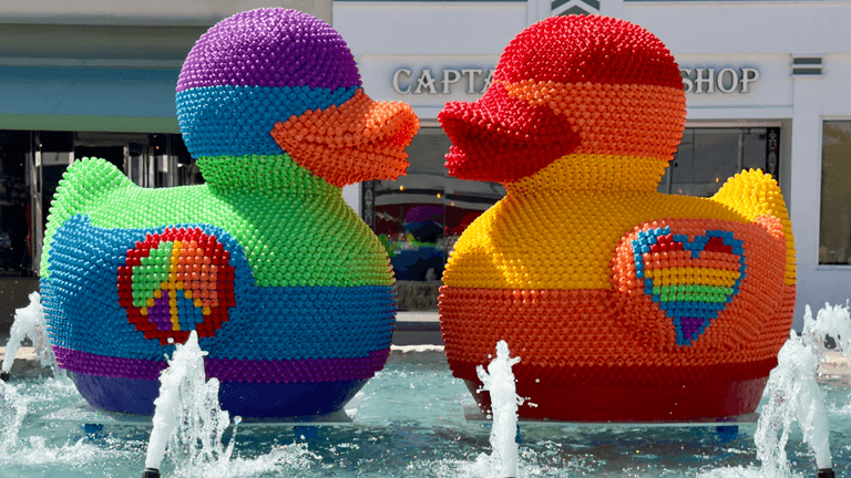 "FLY Miami Art’s colorful rubber duck sculptures, representing unity and resilience, symbolizing love and inclusivity in public art."