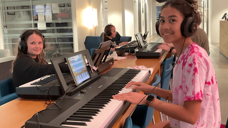 Students engaged in Obbligato Music's Piano Playground program, learning piano in a fun, supportive, and community-focused environment.