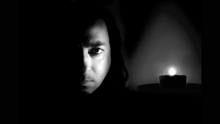 Explore the striking contrast and emotional depth of this black and white portrait featuring a mysterious figure illuminated by candlelight. Perfect for capturing the essence of drama and emotion in photography