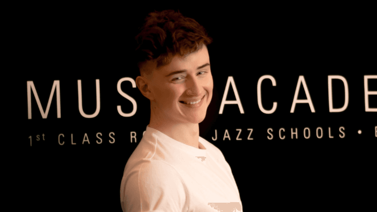 Jonah Schwickert, Boogie Woogie Mastery founder, smiling at music academy, sharing his passion for piano education.