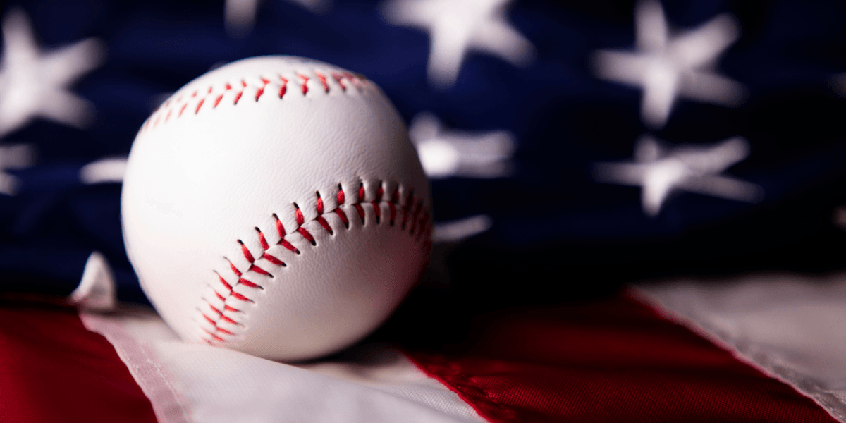 Baseball resting on an American flag representing MLB All-Star Week and America's pastime