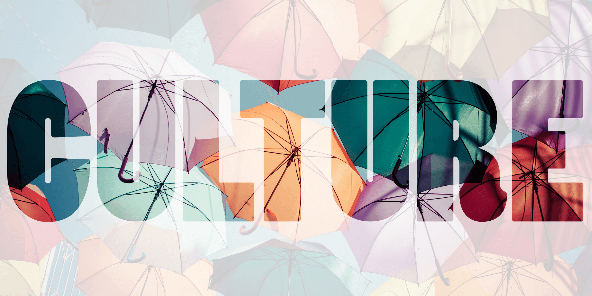 Colorful umbrellas suspended overhead with the word "CULTURE" overlaid across the image.