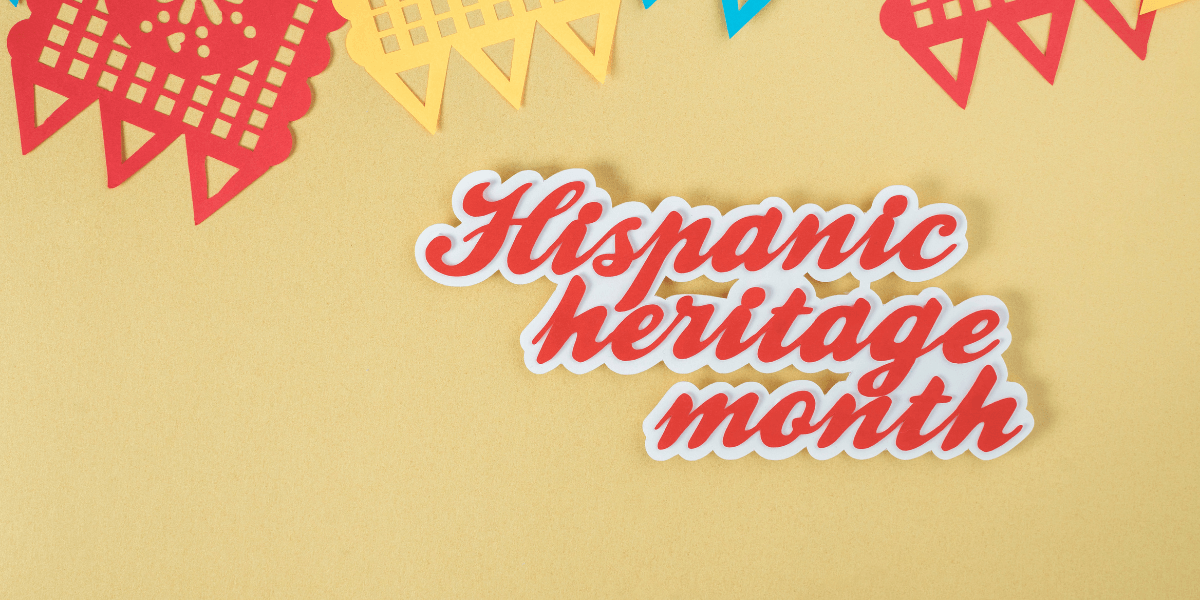 Colorful papel picado decorations with the text Hispanic heritage month on a yellow background