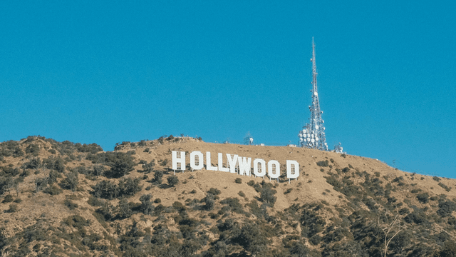 Hollywood sign on a hillside with a clear blue sky backdrop