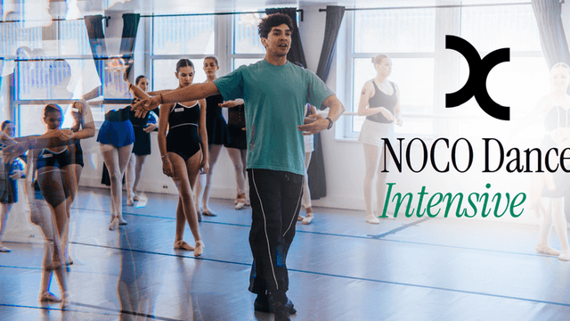 Dance instructor guiding students in a ballet class with a mirrored background