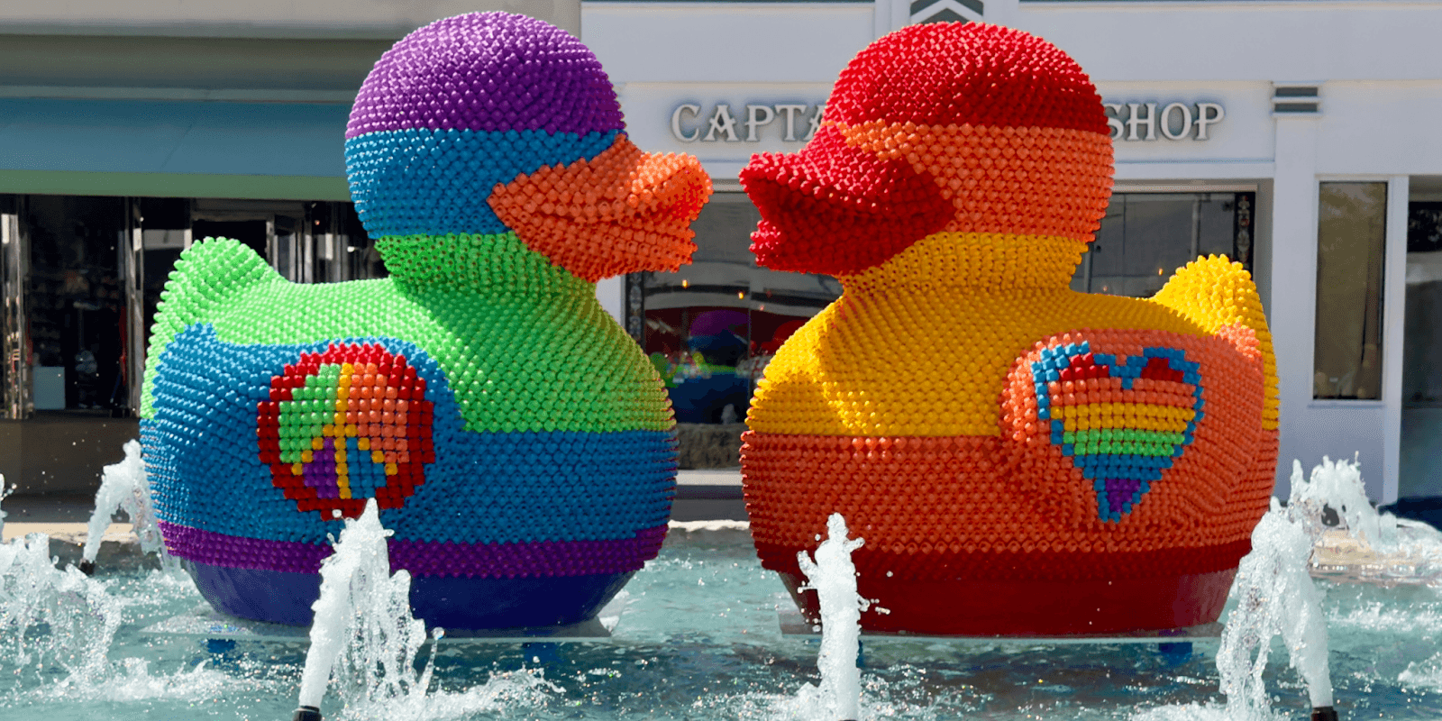 "FLY Miami Art’s colorful rubber duck sculptures, representing unity and resilience, symbolizing love and inclusivity in public art."