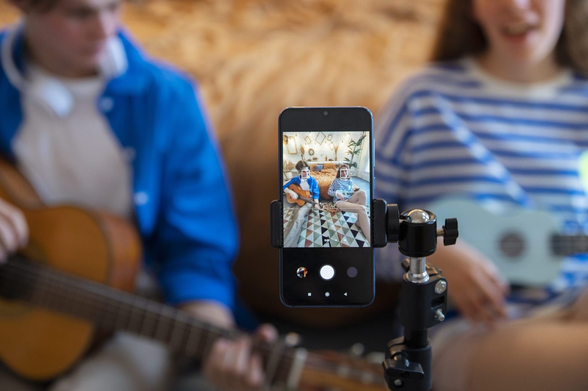 Teenage Boy Girl Recording Music Their Home Studio With Guitar