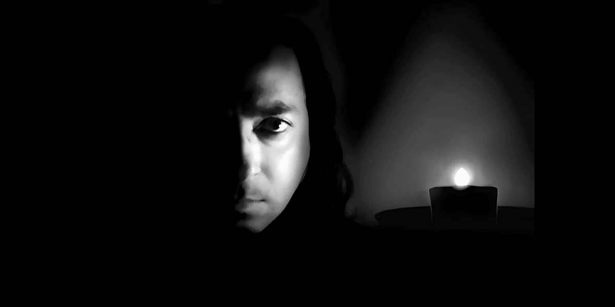 Explore the striking contrast and emotional depth of this black and white portrait featuring a mysterious figure illuminated by candlelight. Perfect for capturing the essence of drama and emotion in photography