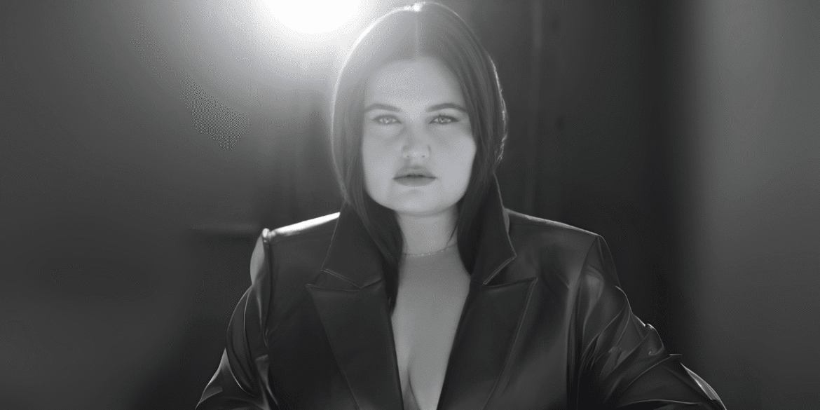 ANEVIIA in dramatic lighting, wearing a dark leather jacket, symbolizing her artistic transformation and rebirth.