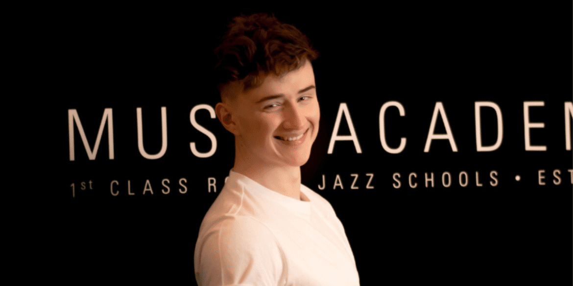Jonah Schwickert, Boogie Woogie Mastery founder, smiling at music academy, sharing his passion for piano education.