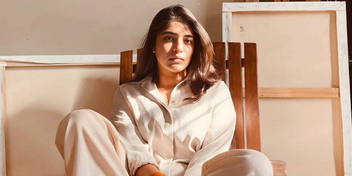 The image features Noor Diwan Goyal, an abstract artist, sitting in a relaxed pose, reflecting deep emotion and introspection.