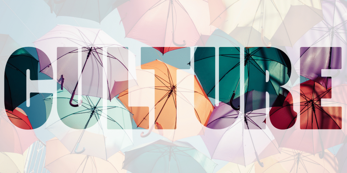 Colorful umbrellas suspended overhead with the word "CULTURE" overlaid across the image.